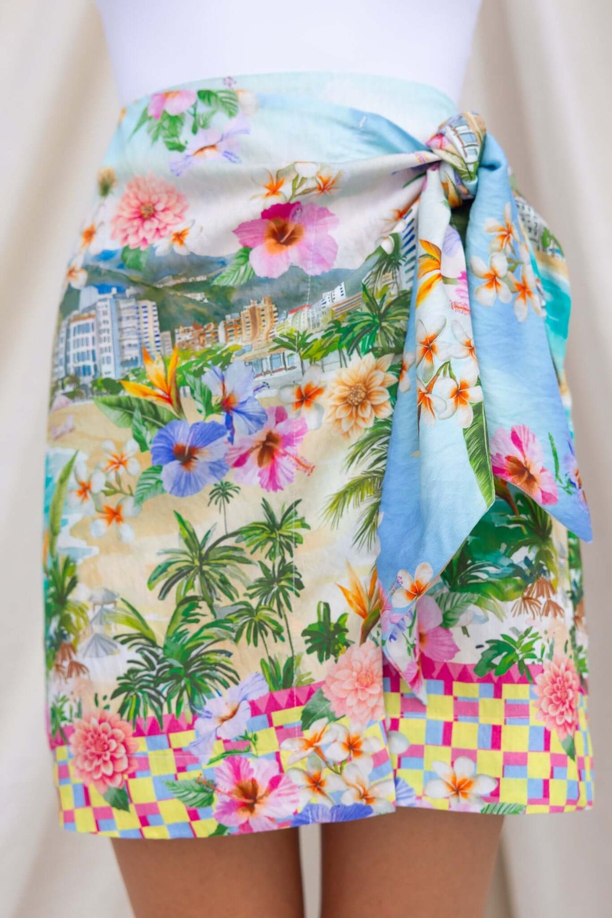 Colorful Hanni Skirt featuring a wrap tie, mid-high waist fit, tropical floral print, and lined fabric.
