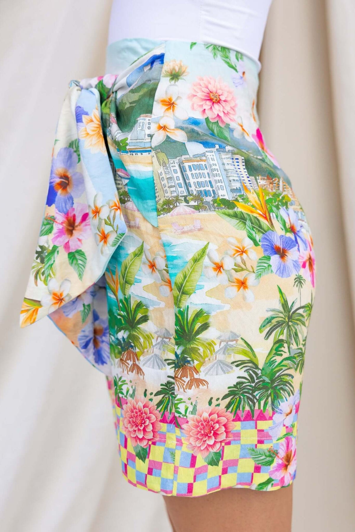 Colorful Hanni Skirt featuring wrap tie, mid-high waist, and floral tropical print design, perfect for summer wear.