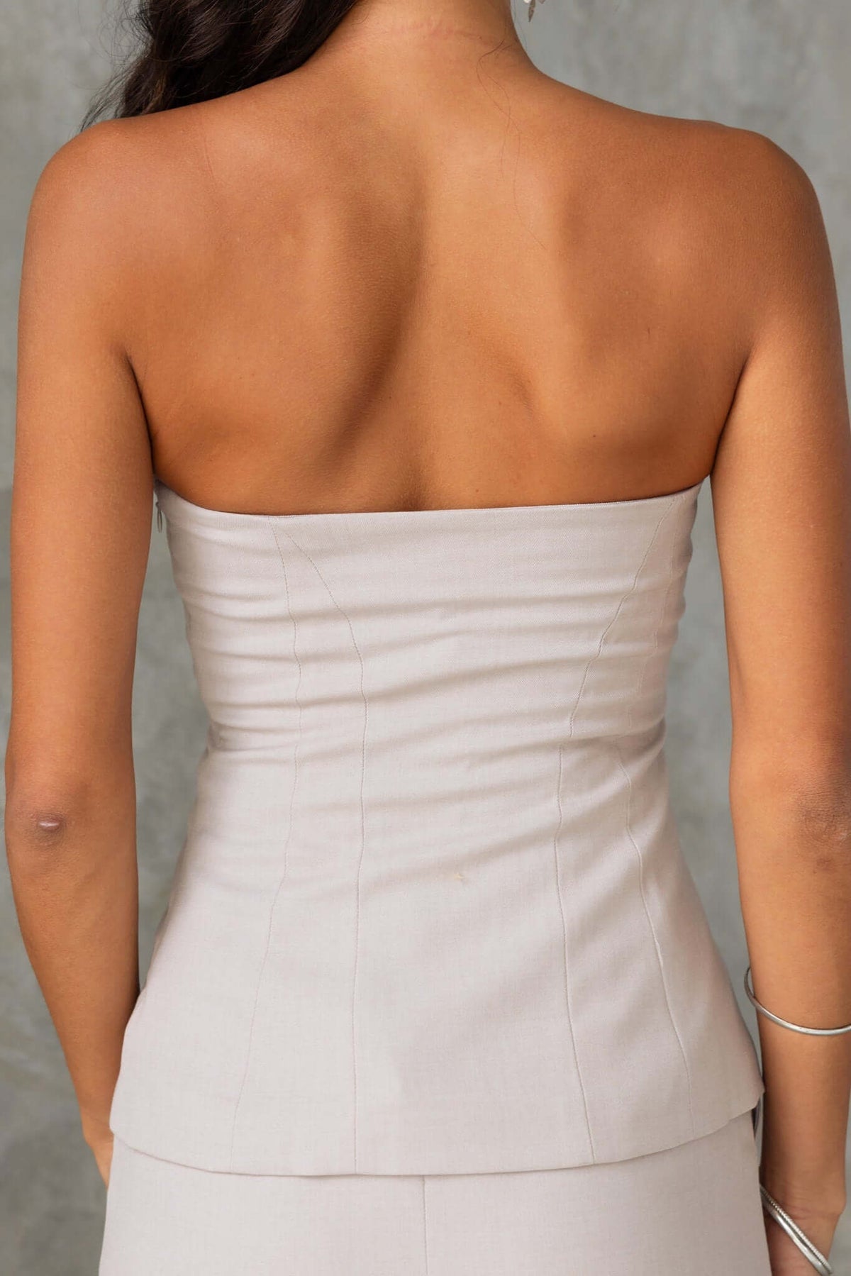 Back view of the strapless Lanetta Top, featuring a fitted design and subtle texture.