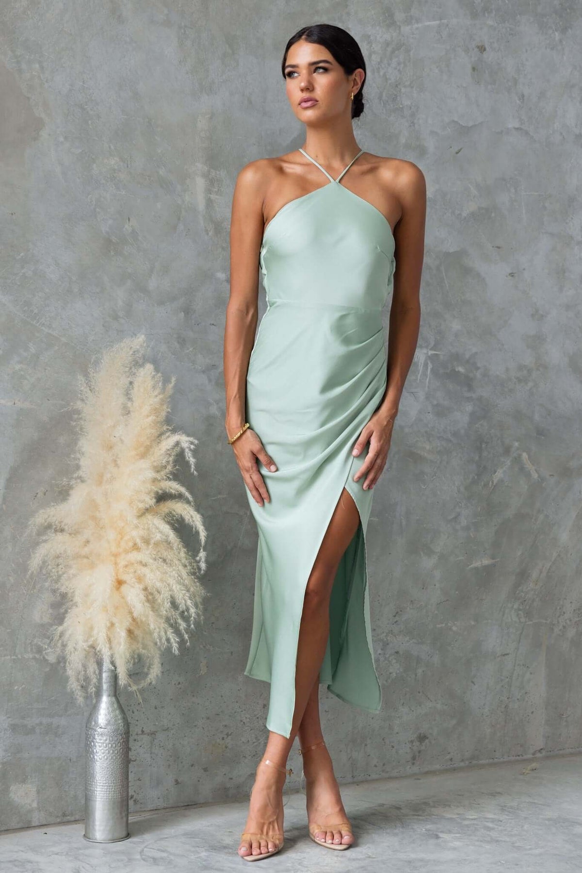 Farida Maxi Dress in soft green featuring adjustable tie straps and a stylish side slit, perfect for elegant occasions.