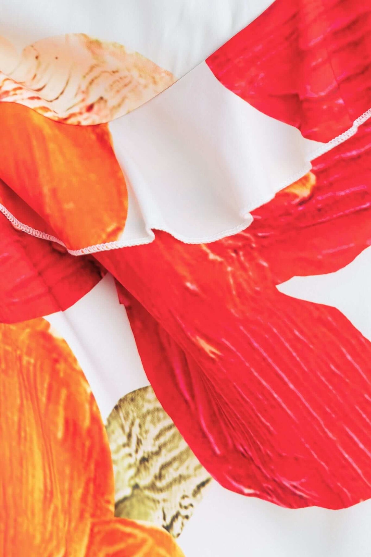 Close-up of vibrant flower print on the Larni Maxi Dress showcasing its colorful design and smooth fabric texture.