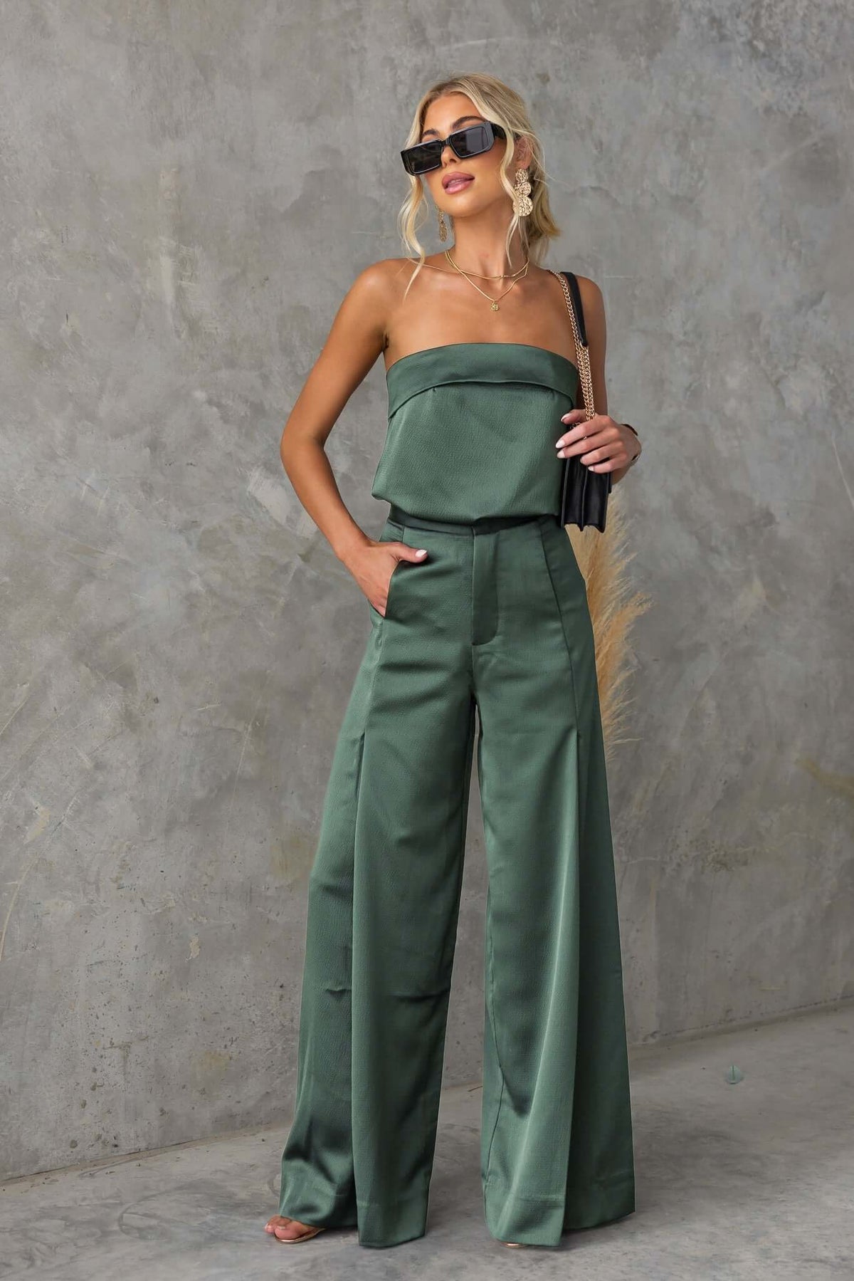 Model wearing Hampton Style Pants in green, featuring a mid-high waist, wide legs, and a stylish, non-stretch material.