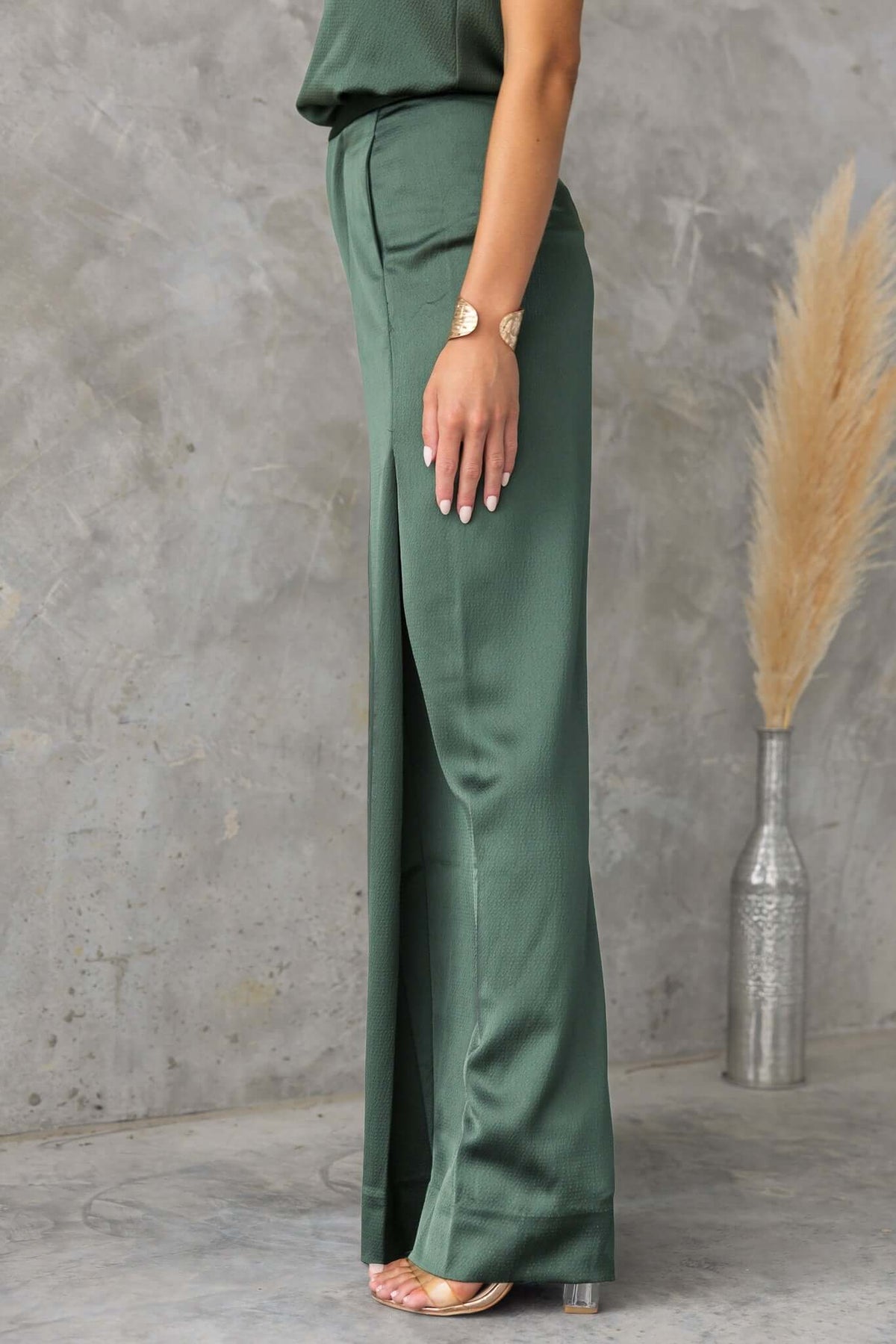 Hampton Style Pants in green, featuring a mid-high waist fit and wide legs, styled with a sleek top and accessories.