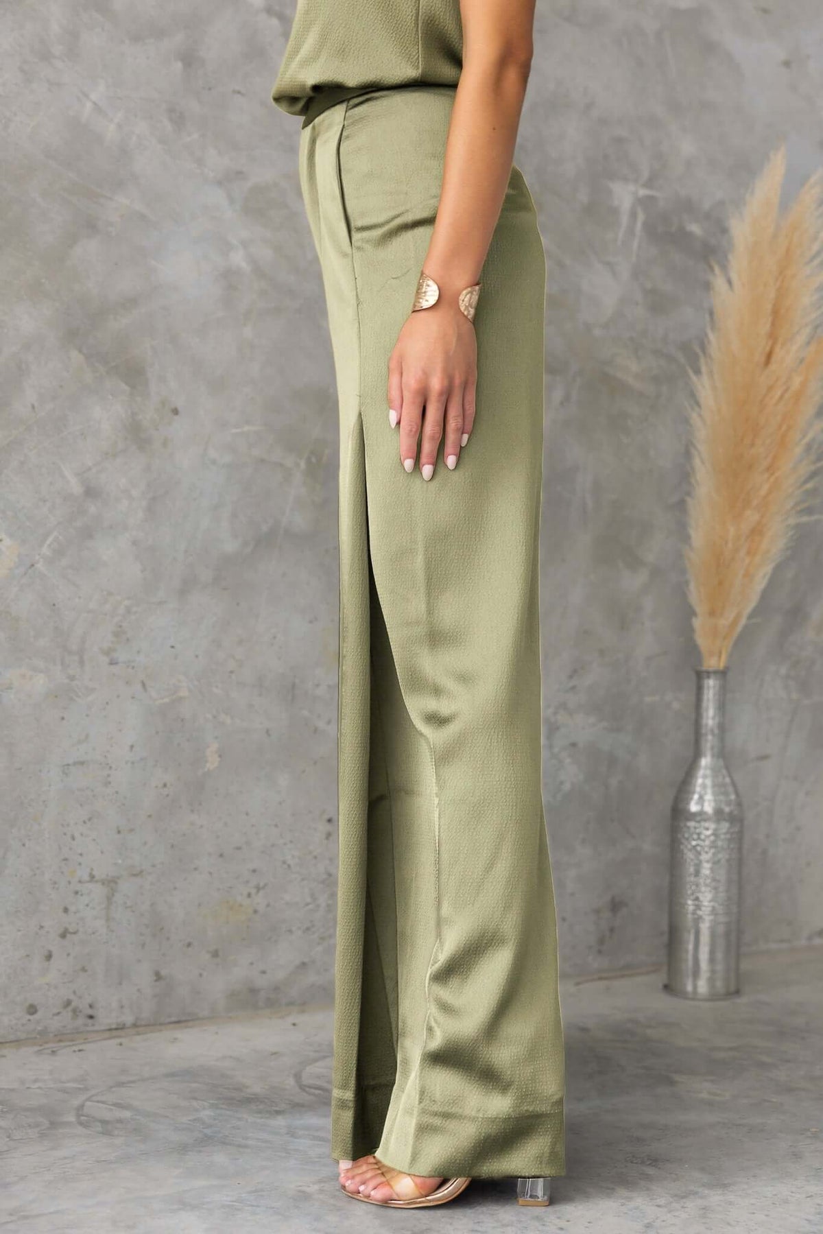 Hampton style pants in olive green, featuring a mid-high waist, wide legs, and lightly textured material.