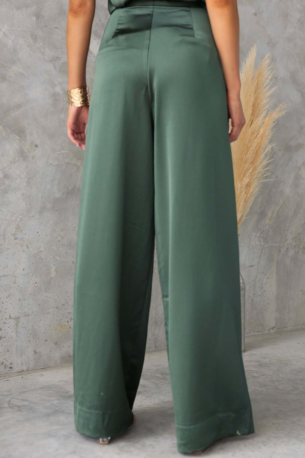 Back view of Hampton Style Pants showcasing mid-high waist fit and wide legs in a soft green hue.