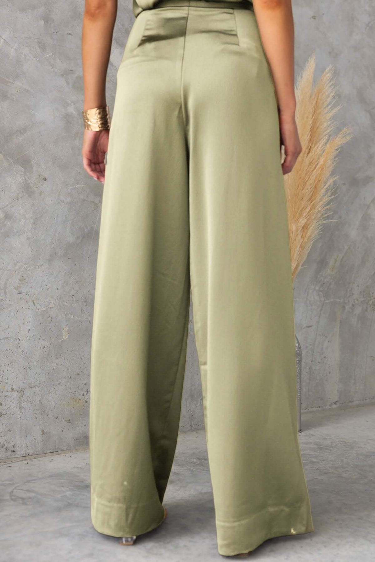 Back view of Hampton Style Pants in light green, featuring wide legs and mid-high waist design, perfect for a stylish look.