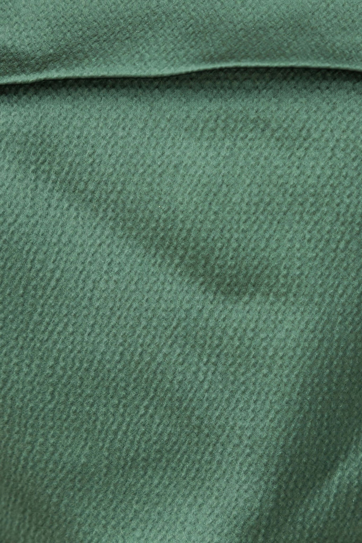 Close-up of lightly textured green fabric used in Hampton Style Pants, showcasing its soft surface for a stylish look.