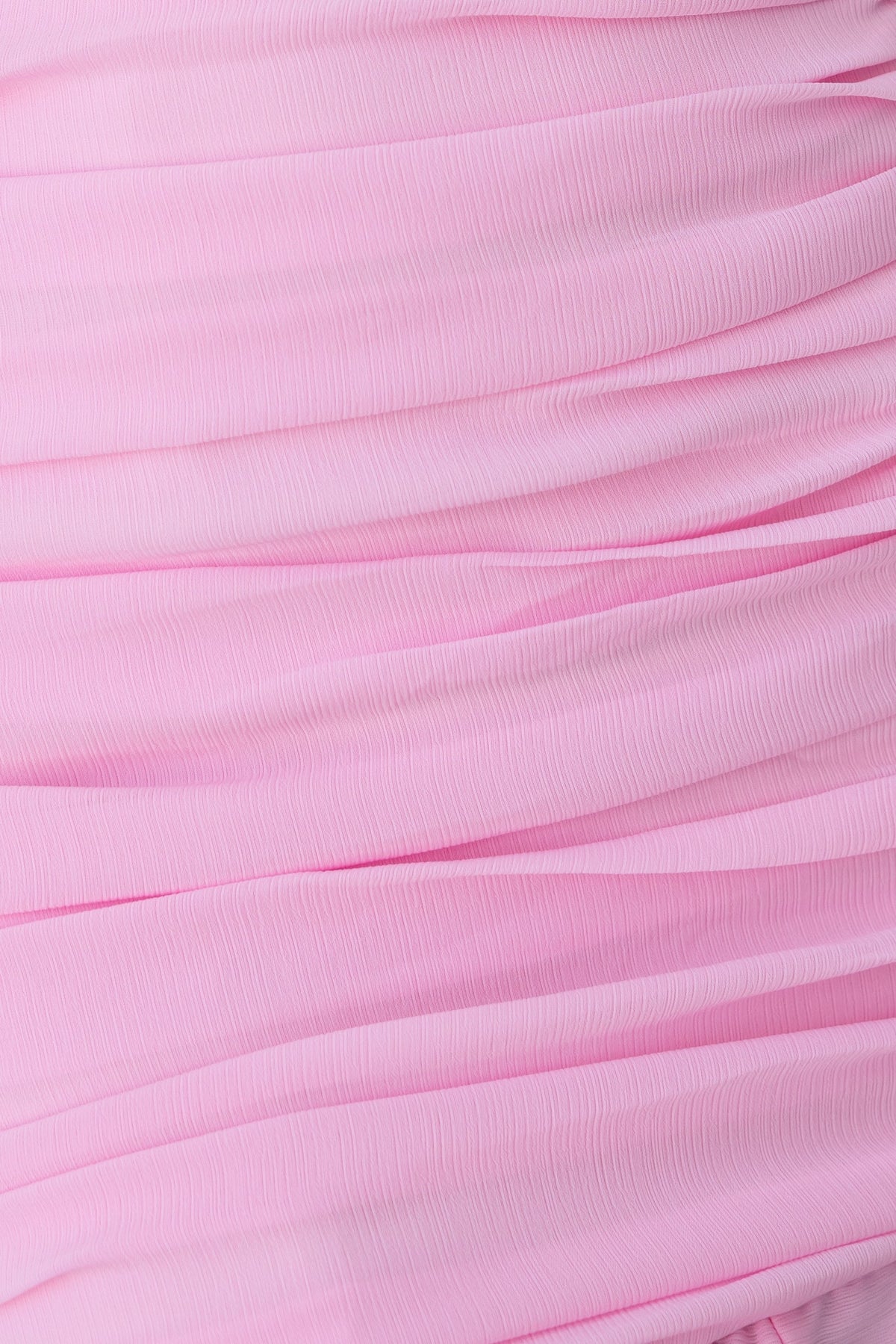 Pink ruched fabric close-up, perfect for a stylish maxi dress design.