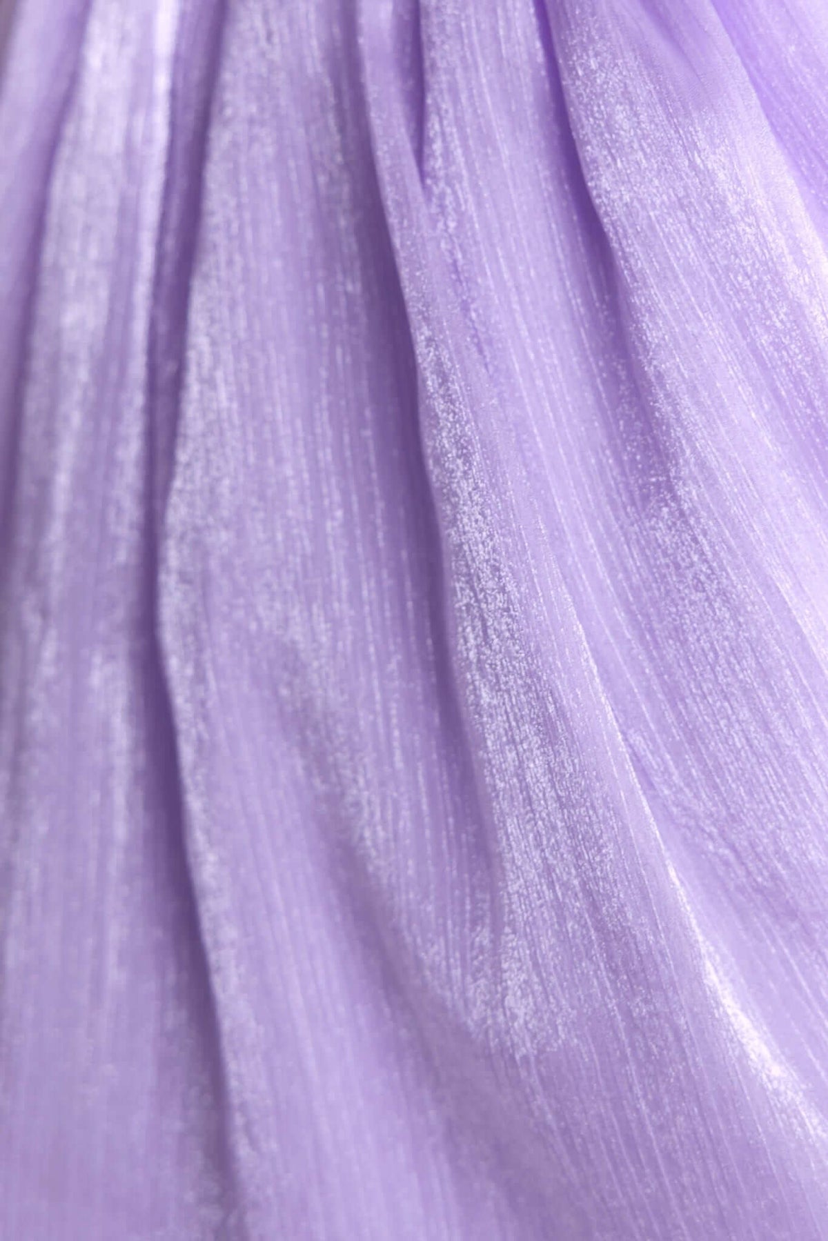Close-up of soft, shimmering lilac fabric ideal for the Irena Dress, showcasing its elegant texture and sheen.