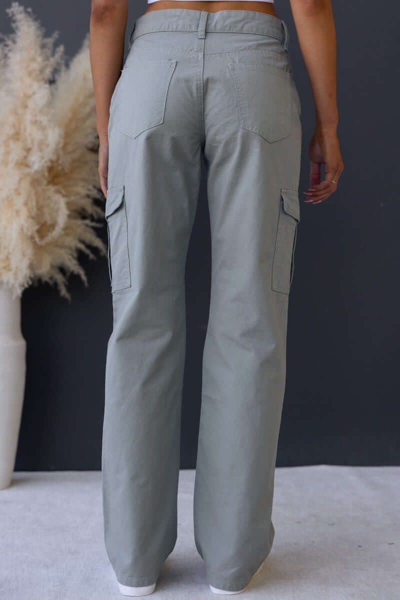 Back view of Bowie cargo pants in grey, featuring wide legs and cargo pockets for a stylish and functional look.