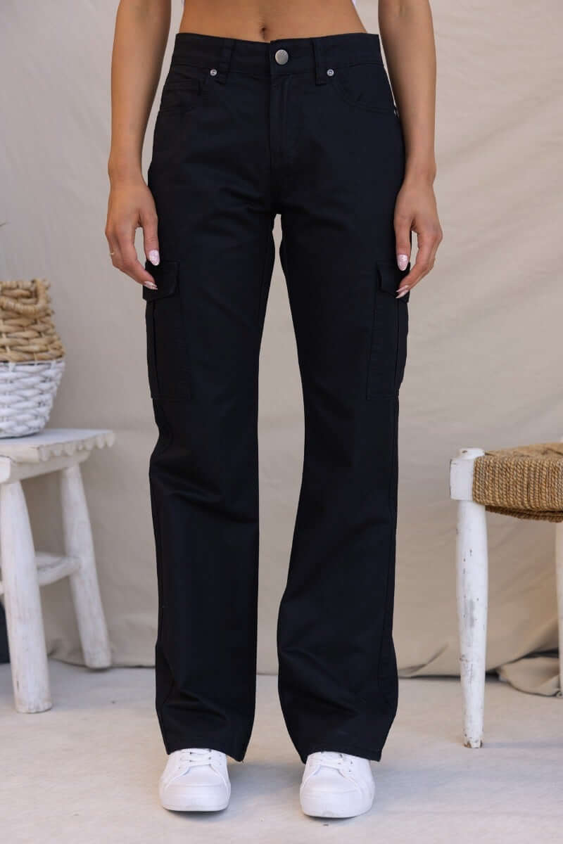 Black Bowie Cargo Pants with wide legs, low-mid waist fit, and pockets, styled with a casual outfit.