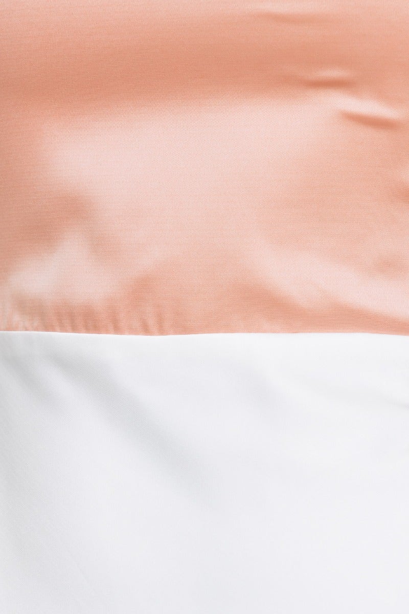 Close-up of the satin fabric in peach and white, highlighting the colors of the Katya Maxi Dress.