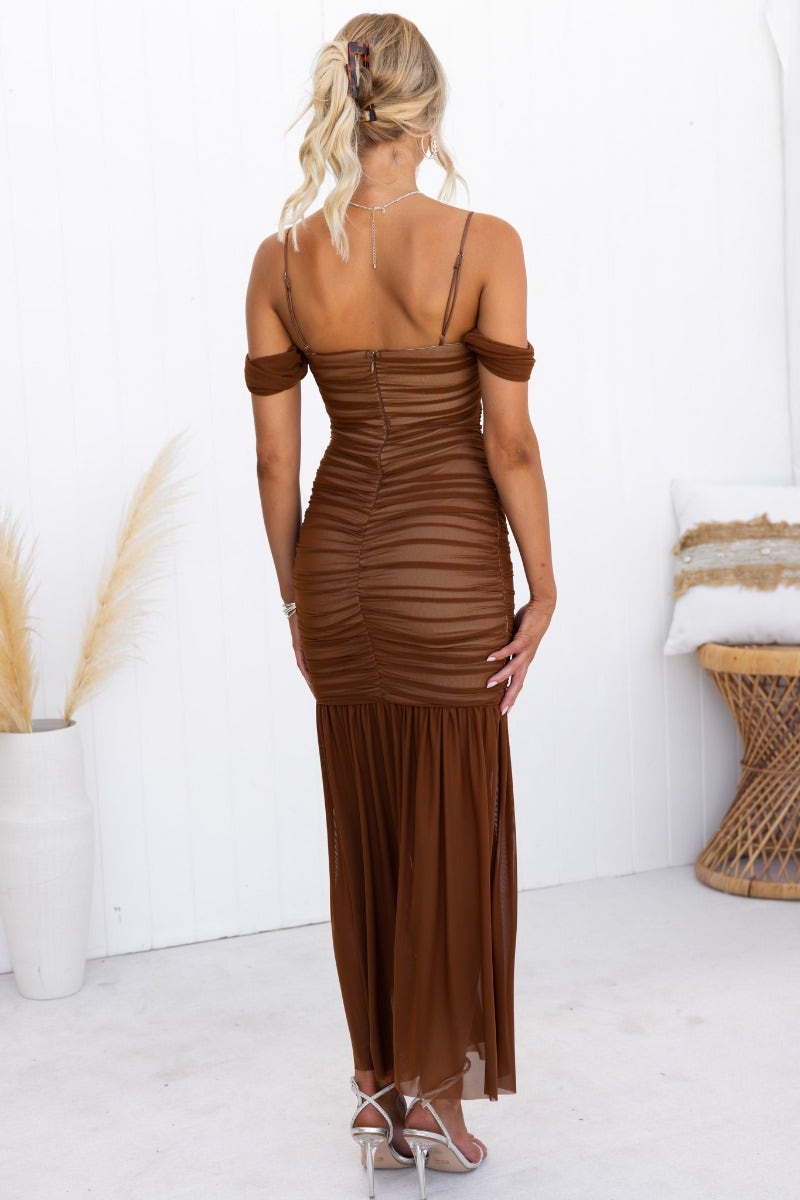 Back view of a brown Milan maxi dress featuring ruching, adjustable straps, and a flowy skirt.