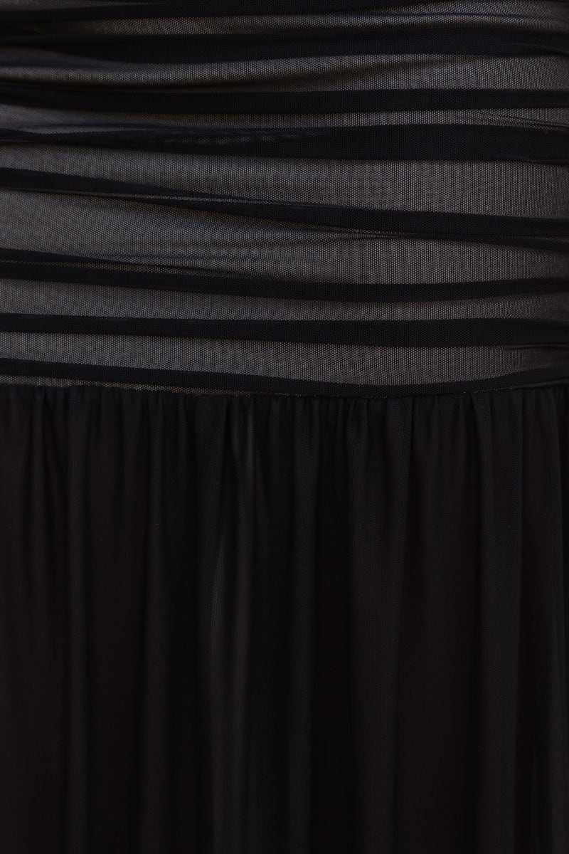 Close-up of Milan Maxi Dress showing black mesh overlay, ruching, and soft fabric detail in a layered design.