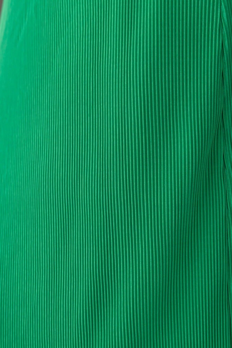 Close-up of green accordion pleat fabric of the Wondrous Top, showcasing texture and color.