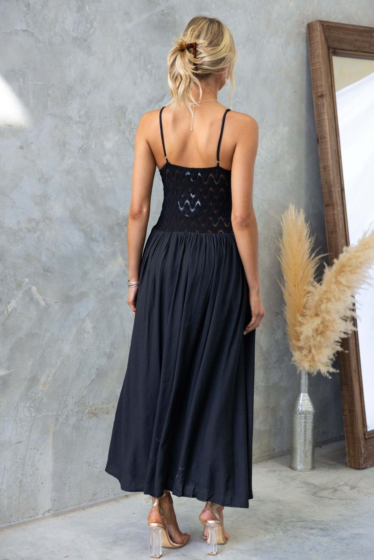 Back view of Thaisa Maxi Dress with adjustable straps and lace bodice, styled with a natural backdrop.