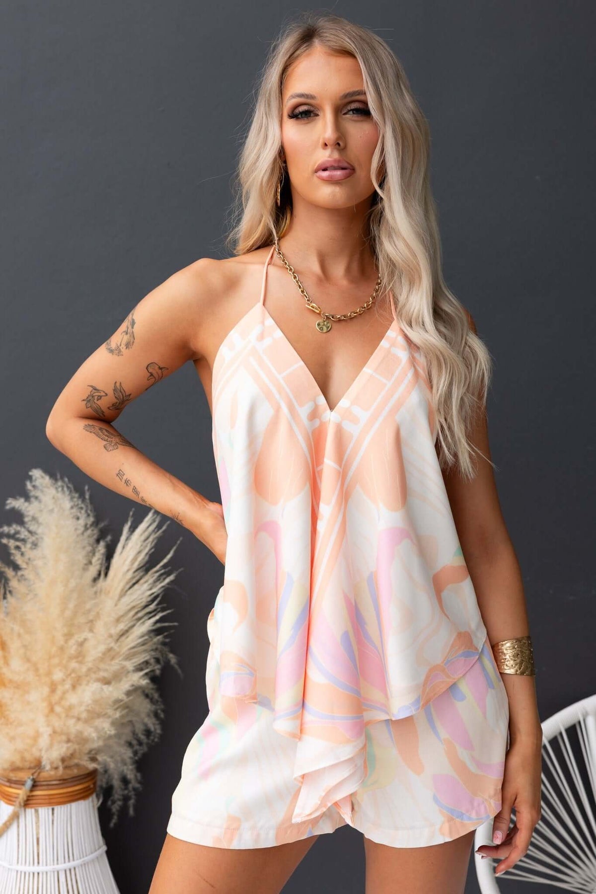 Model wearing Qomiso shorts with a pastel design, showcasing a stylish summer look.