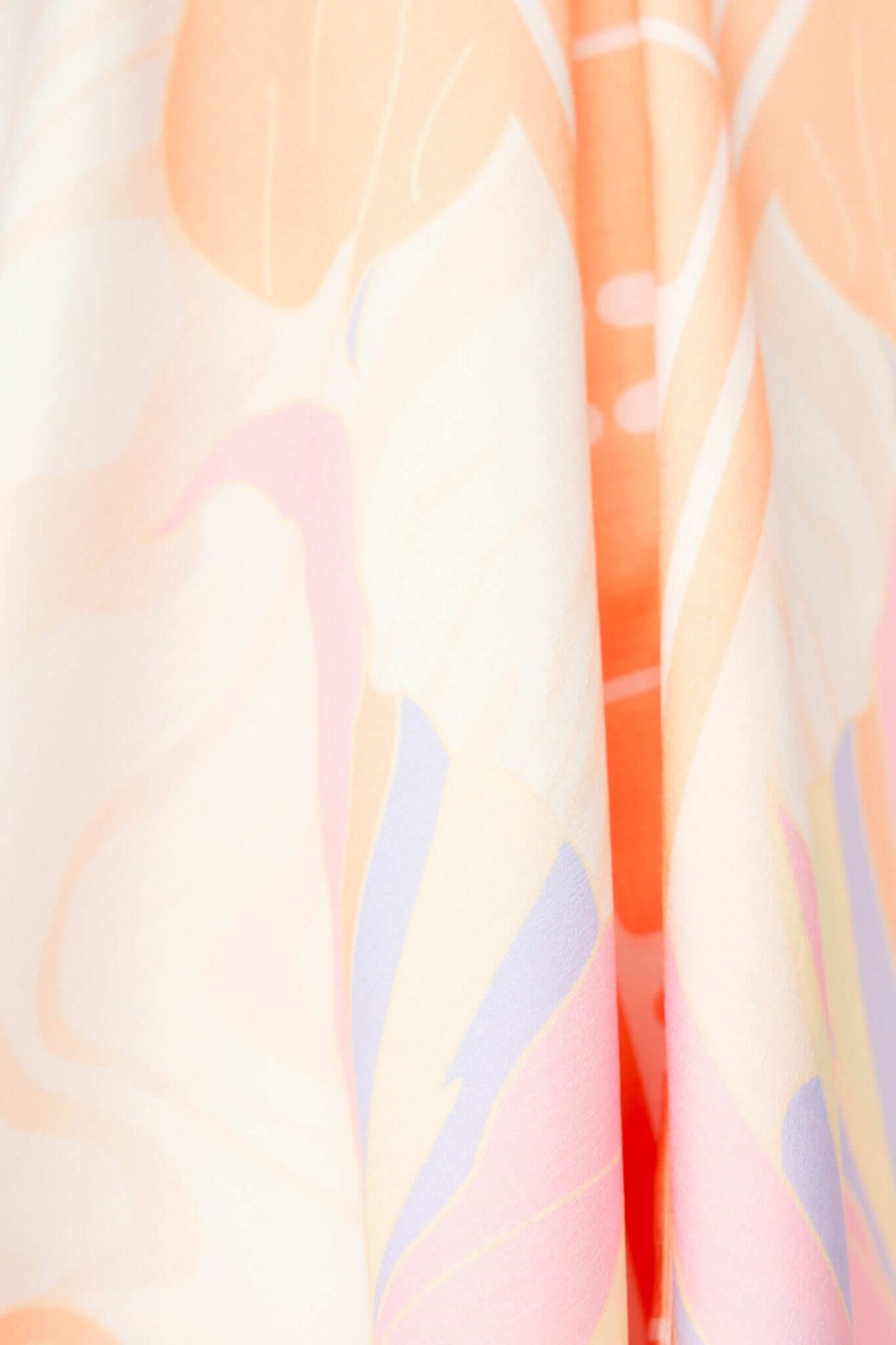 Close-up of vibrant floral fabric in soft colors for Qomiso Top, showcasing a light and breezy design.