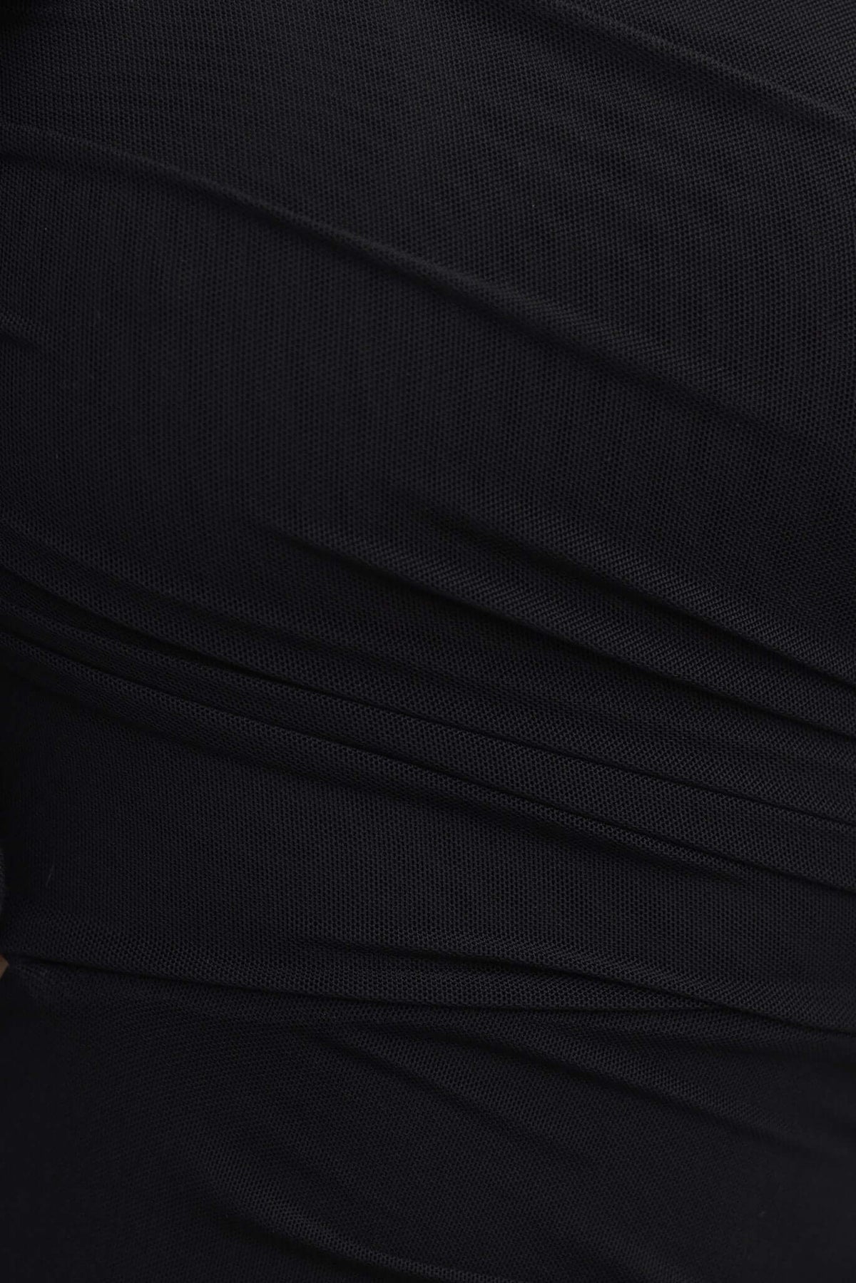 Close-up of black mesh fabric with ruched detail, highlighting the texture of the Meriden Maxi Dress.