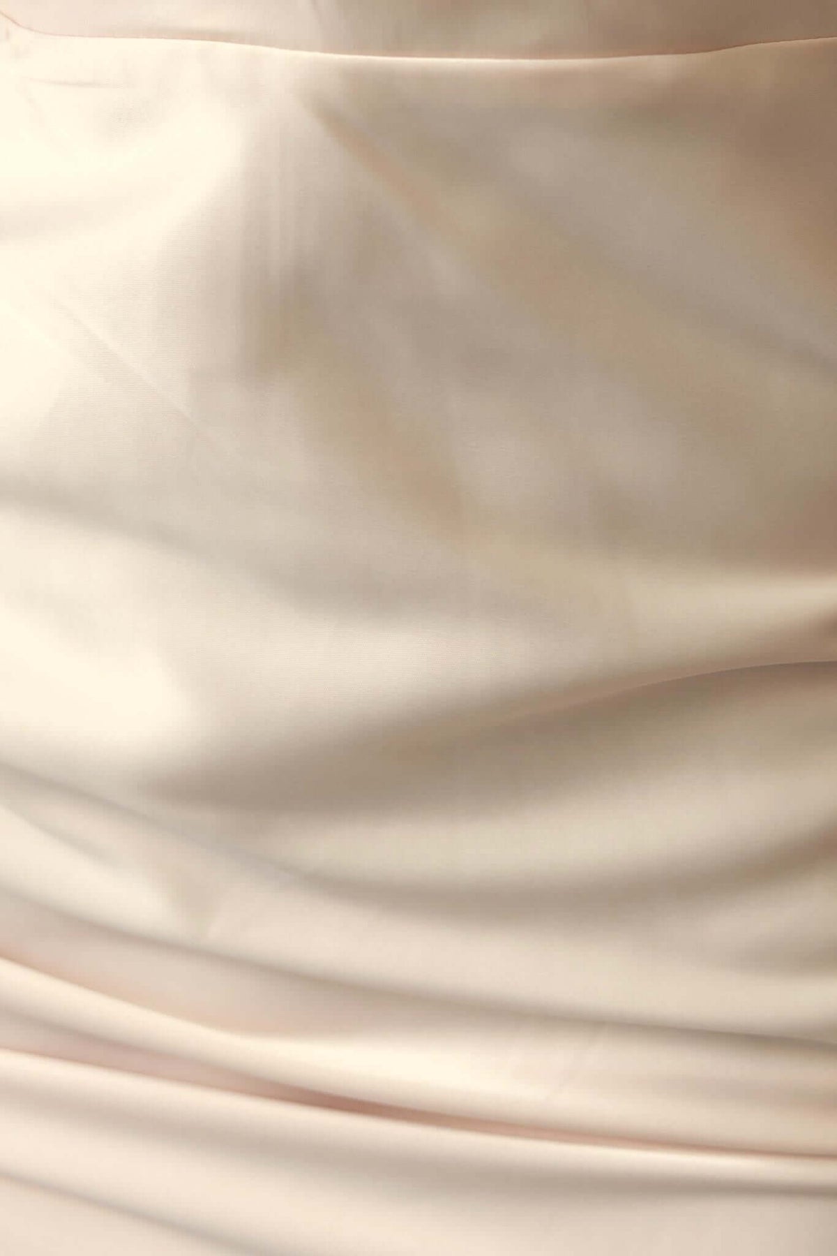 Close-up of luxurious fabric texture of the Qirsti Maxi Dress, showcasing its smooth, elegant material and feminine design.