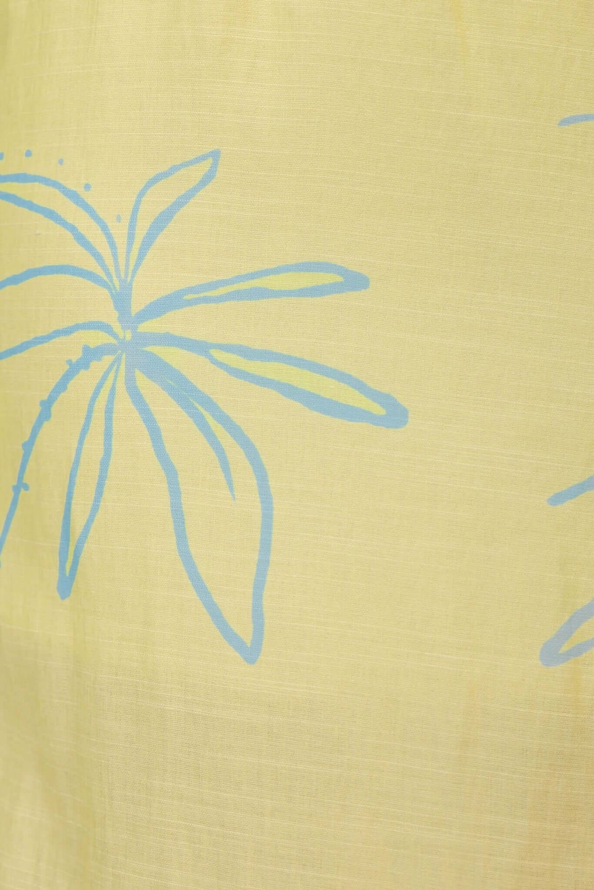 Close-up of Norris Maxi Dress fabric featuring a light yellow background with blue floral design.