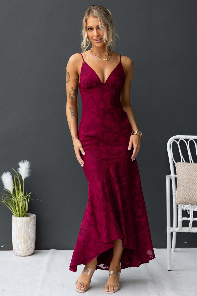 Fontana maxi dress in burgundy with adjustable straps and high-low hem, styled for a chic look.