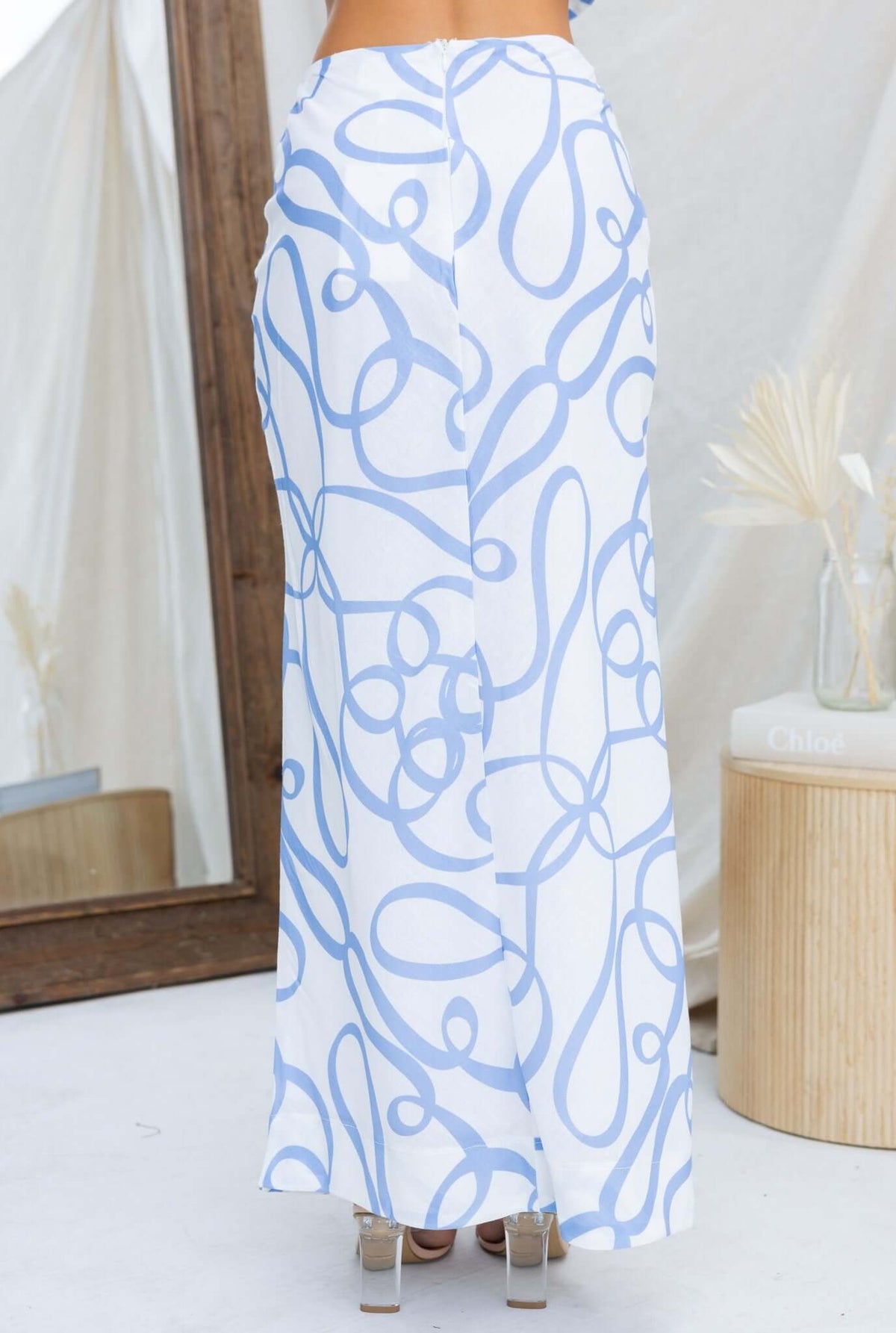 Bexley Maxi Skirt in white and blue pattern, mid-high waist with back slit, perfect for stylish summer outfits.