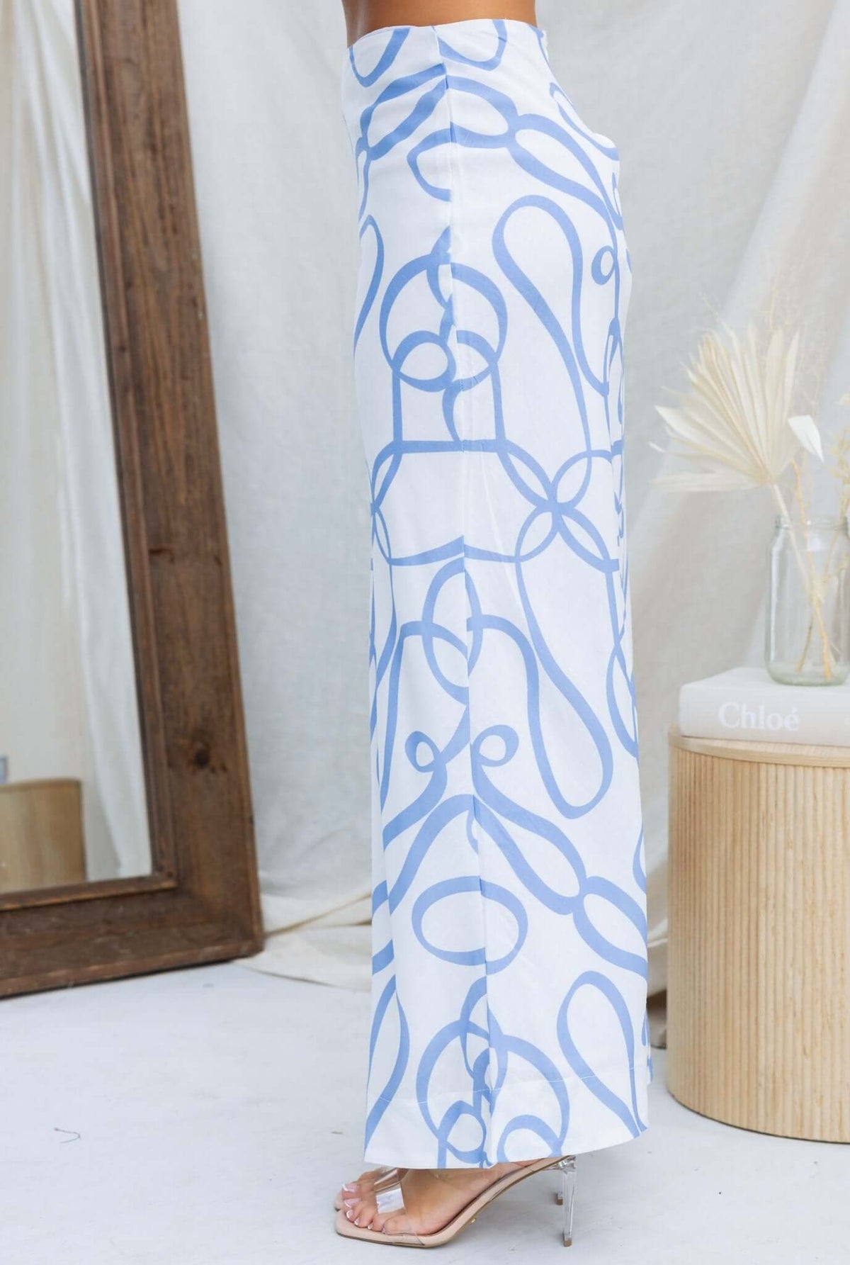 Bexley Maxi Skirt featuring a blue and white pattern, mid-high waist fit, and side view with a mirror backdrop.
