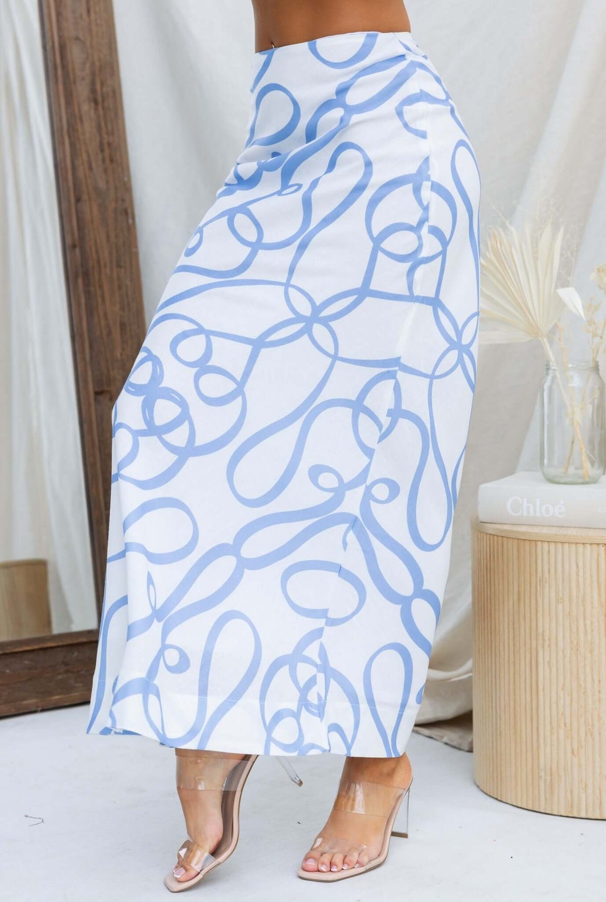 Bexley Maxi Skirt in blue and white abstract pattern, featuring mid-high waist and flowing design.