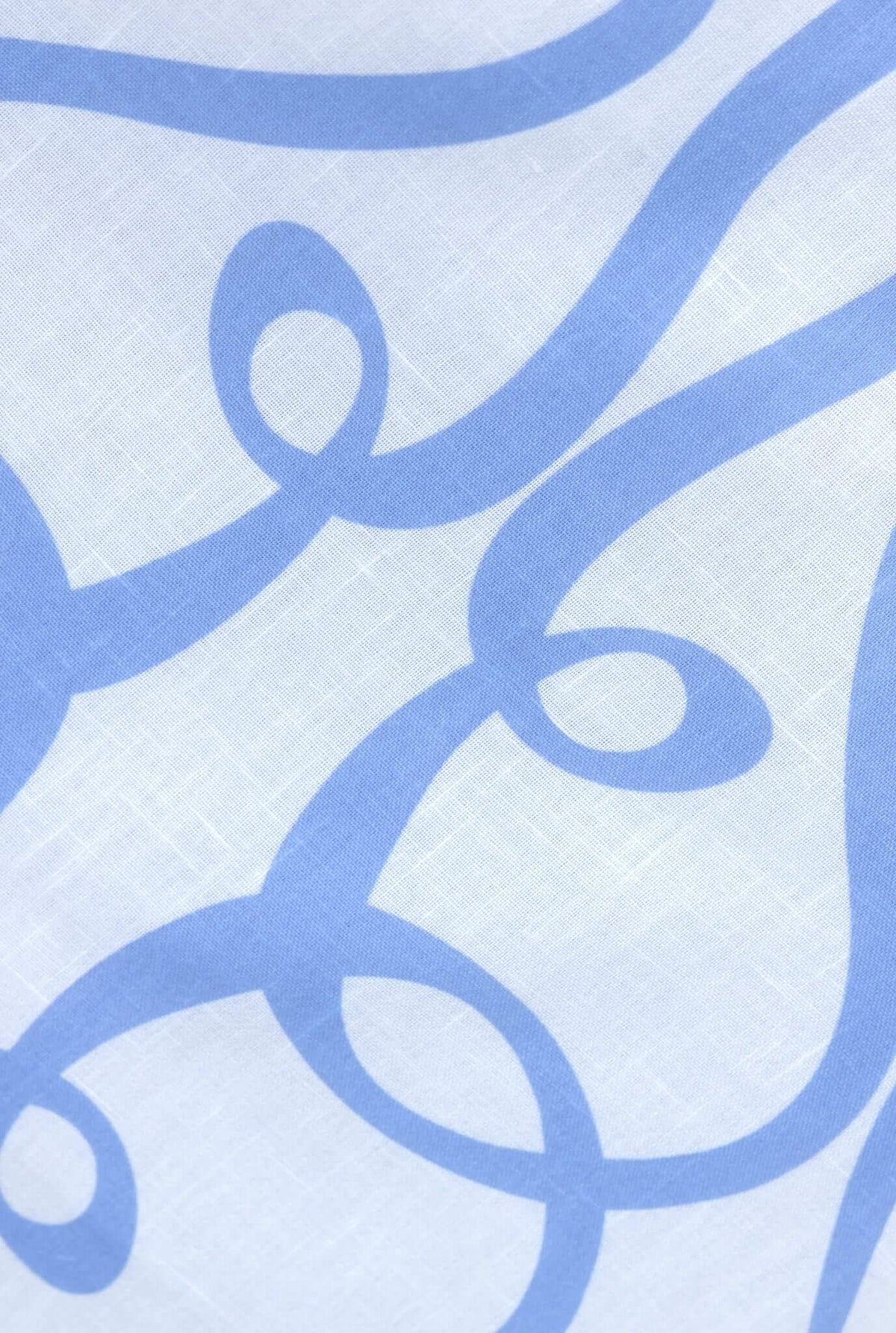 Close-up of light blue swirling pattern on white fabric, showcasing the design of the Bexley Maxi Skirt.
