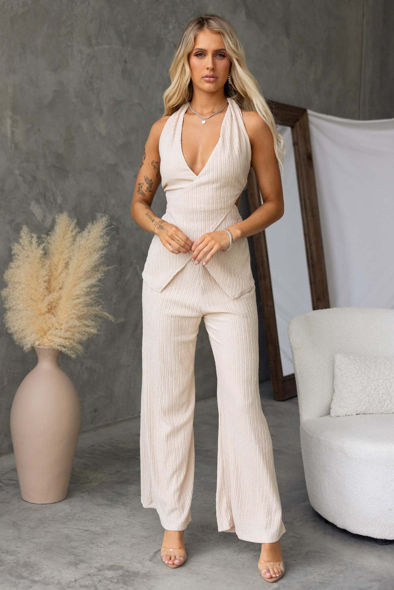 Model showcasing Lisa Pants in a stylish interior, featuring a mid-high waist and elegant design.