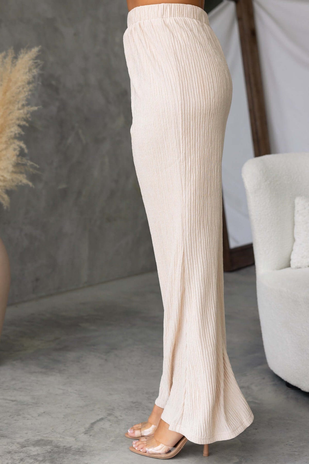 Lisa Pants in beige with a mid-high waist fit and elastic waistband, showcasing a lined design and non-stretch fabric.