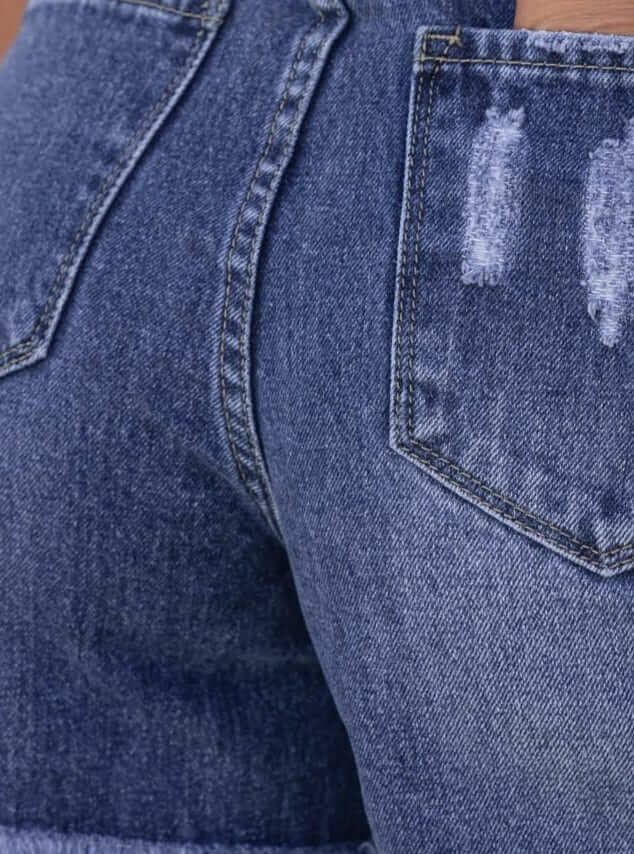 Close-up of Kobe Denim Shorts showing distressed details and frayed hemline with back pockets.