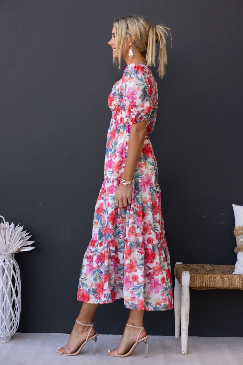 Side view of an Ave Maxi Dress in floral print, featuring a V-neckline and elastic bodice, perfect for casual outings.