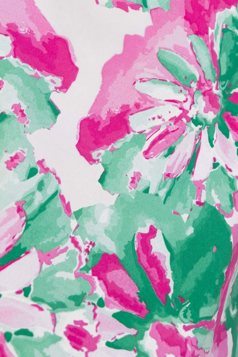 Close-up of vibrant floral print featuring pink and green hues, perfect for a summer maxi dress.