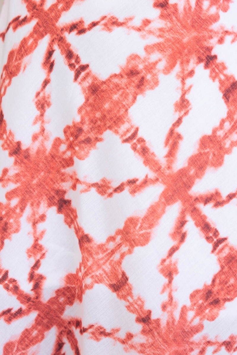 Close-up of red and white patterned fabric, showcasing the unique design of the Cynthia Maxi Dress.