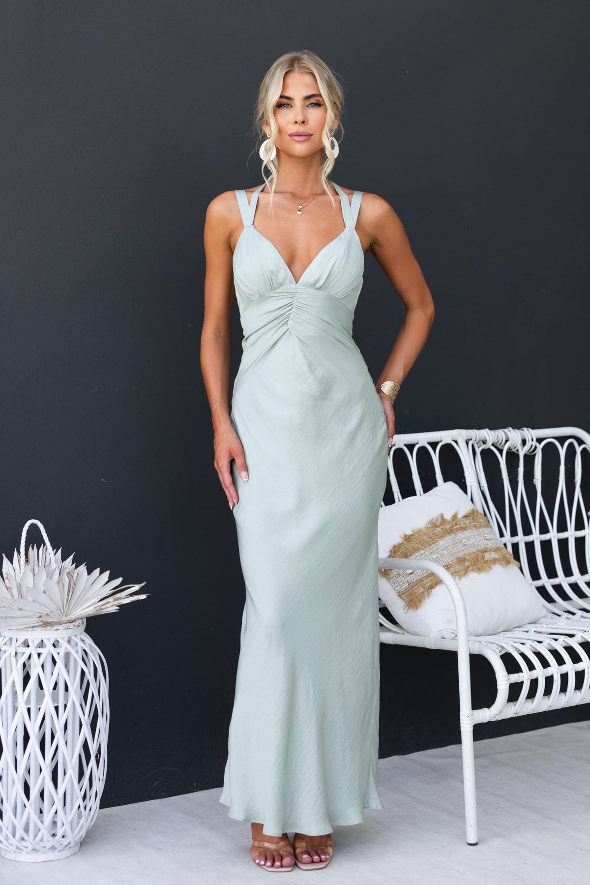 Laken Maxi Dress in soft green with adjustable straps and textured fabric, model posing against a dark background.