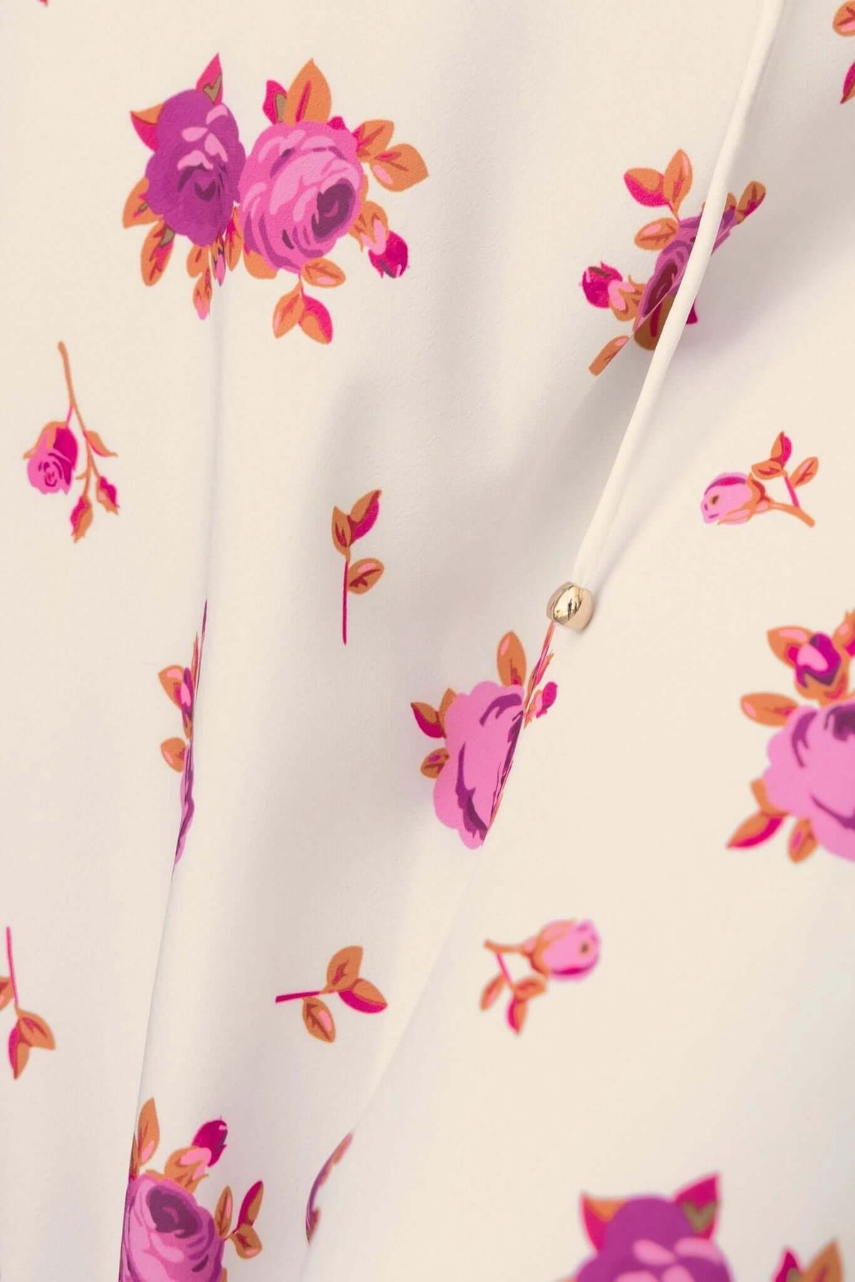 Close-up of floral print fabric on Paige Midi Dress, featuring pink roses and floral accents.