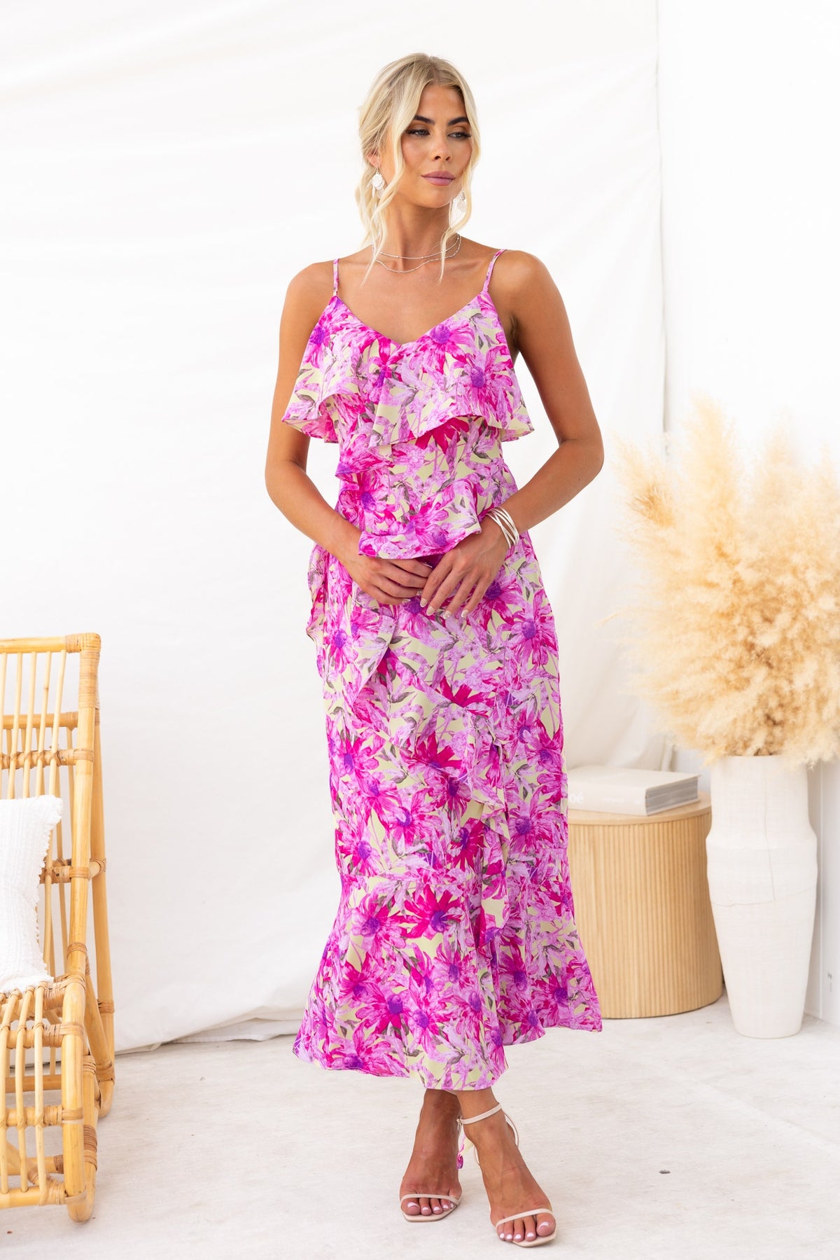 Anissa Maxi Dress with floral print, adjustable straps, and a front split, worn by model in a bright setting.