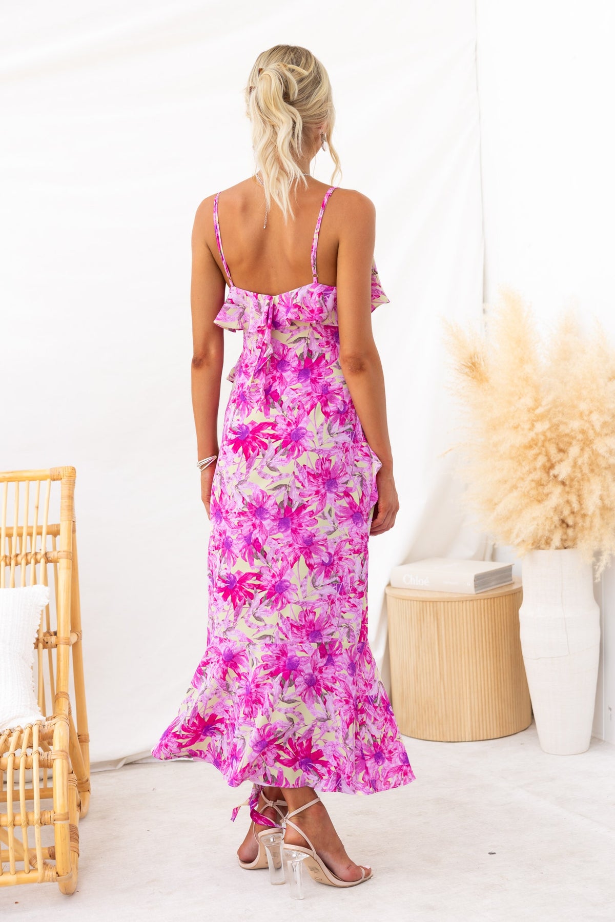 Back view of Anissa Maxi Dress in pink floral print with adjustable straps and ruffle detail, perfect for summer occasions.