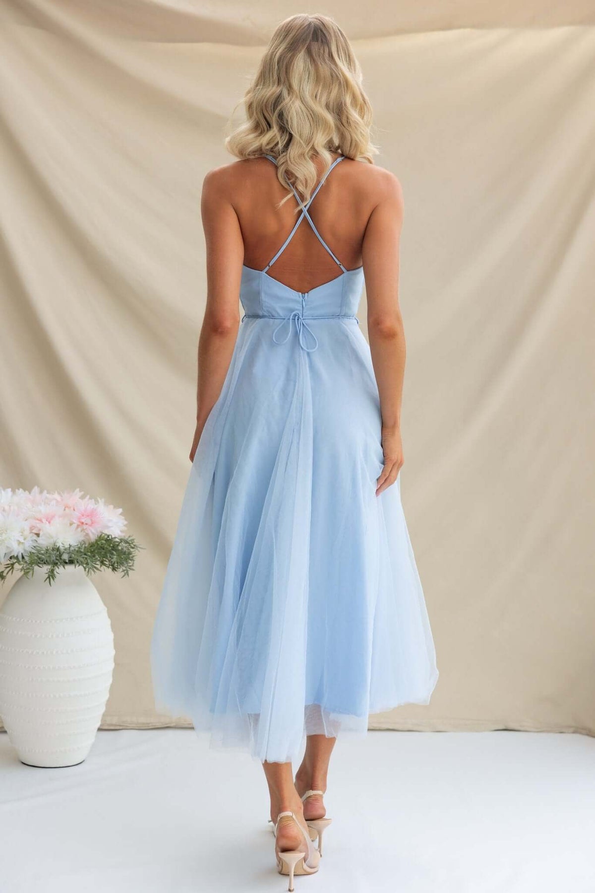 Back view of a light blue Florence Midi Dress showcasing adjustable straps and flowing tulle material.