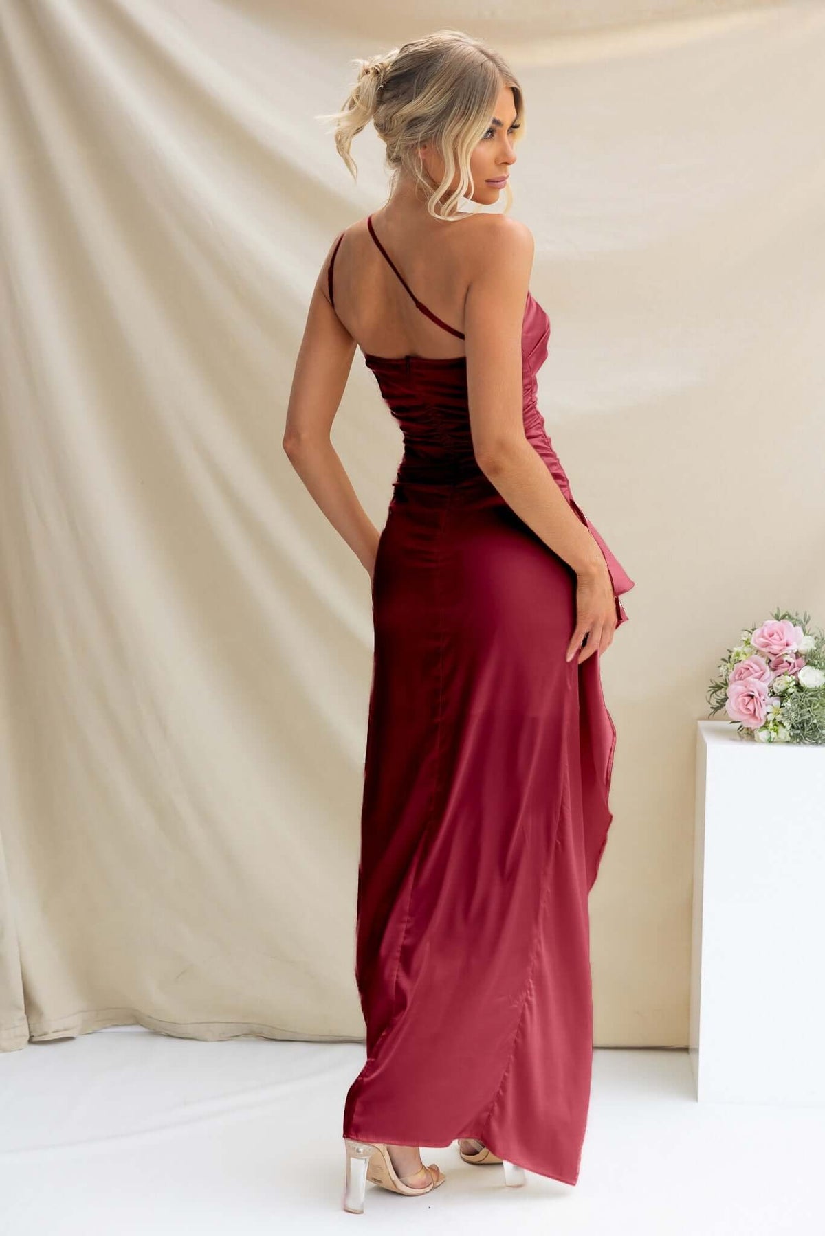Dimmi Maxi Dress in burgundy, featuring a one-shoulder design and ruffle trim, showcasing an elegant evening look.