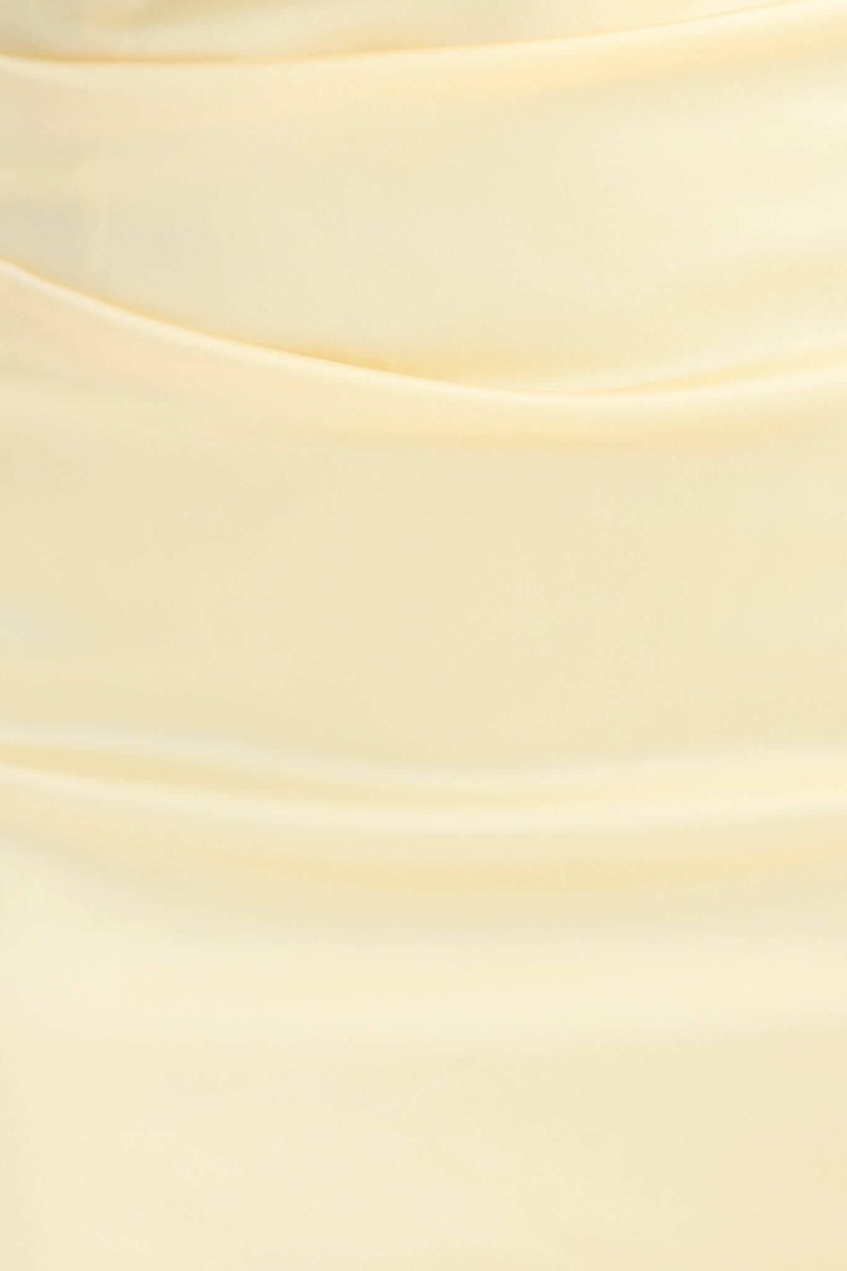 Close-up of soft satin fabric in a pale yellow color, highlighting the elegant drape and texture suited for a maxi dress.