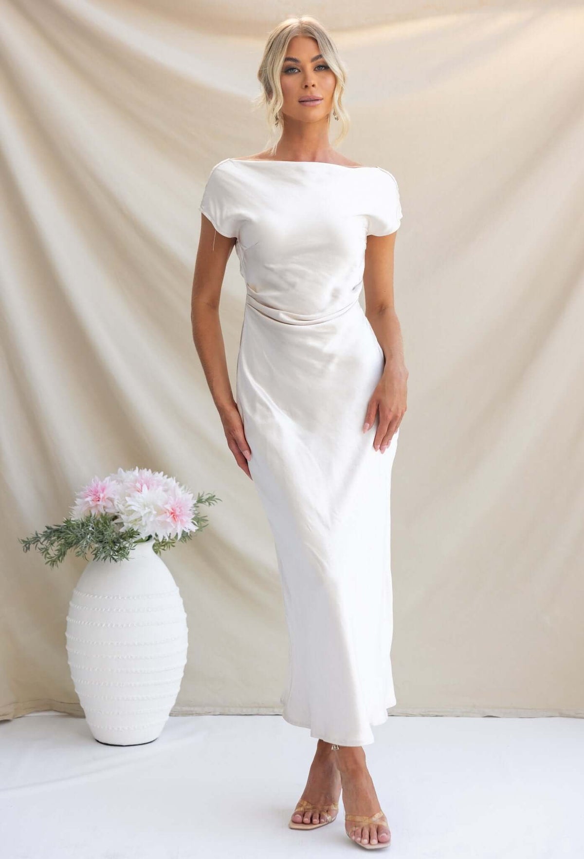 Esmeralda Maxi Dress: Elegant boat neckline, draped back, and satin finish, styled for bridal occasions.