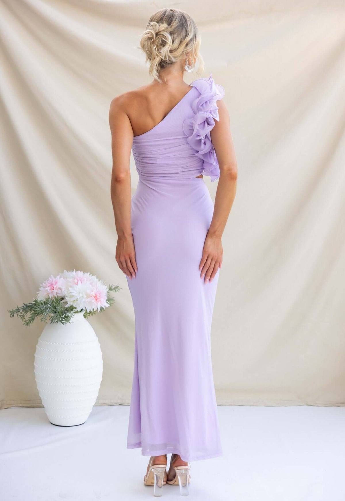 Back view of a lilac Meriden Maxi Dress featuring a one-shoulder design and floral accent.