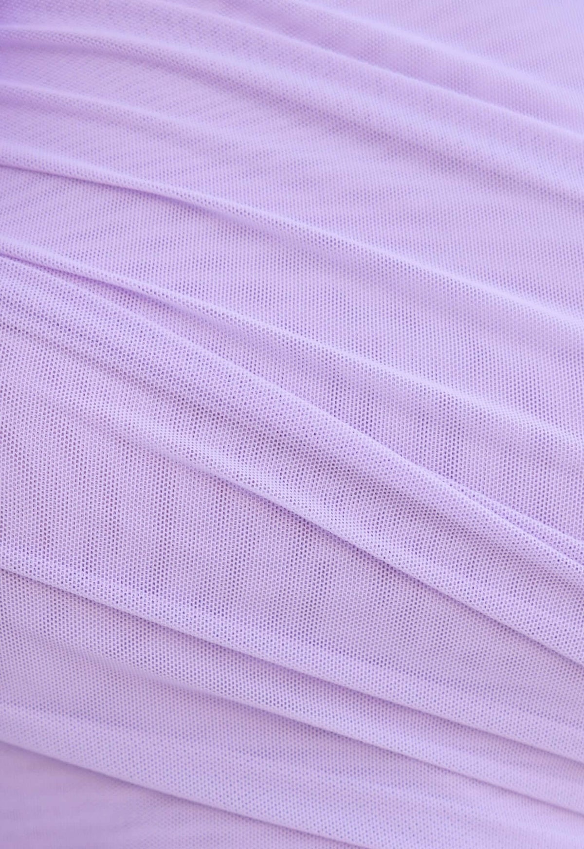 Close-up of light purple mesh fabric with delicate pleats, ideal for stylish garments like the Meriden Maxi Dress.