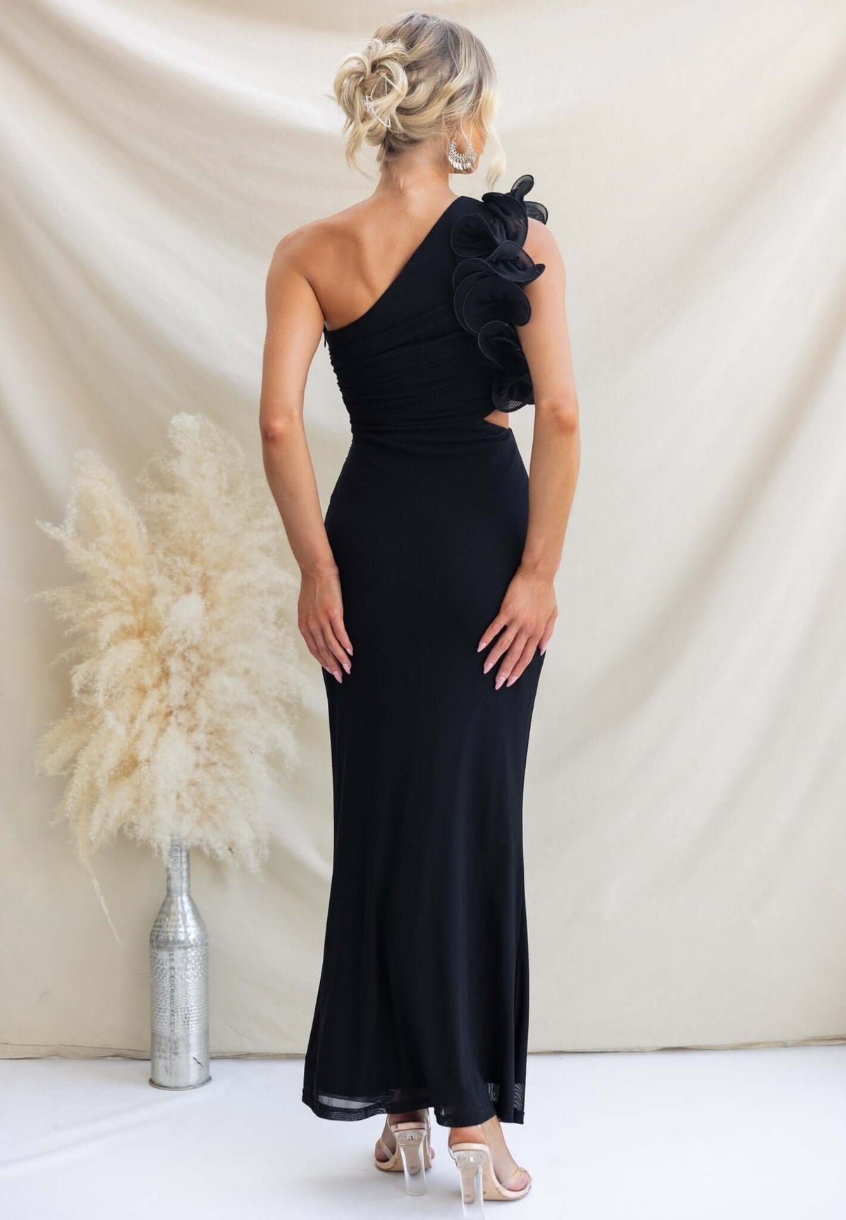 Back view of the black Meriden Maxi Dress featuring one-shoulder neckline and ruffle detail.