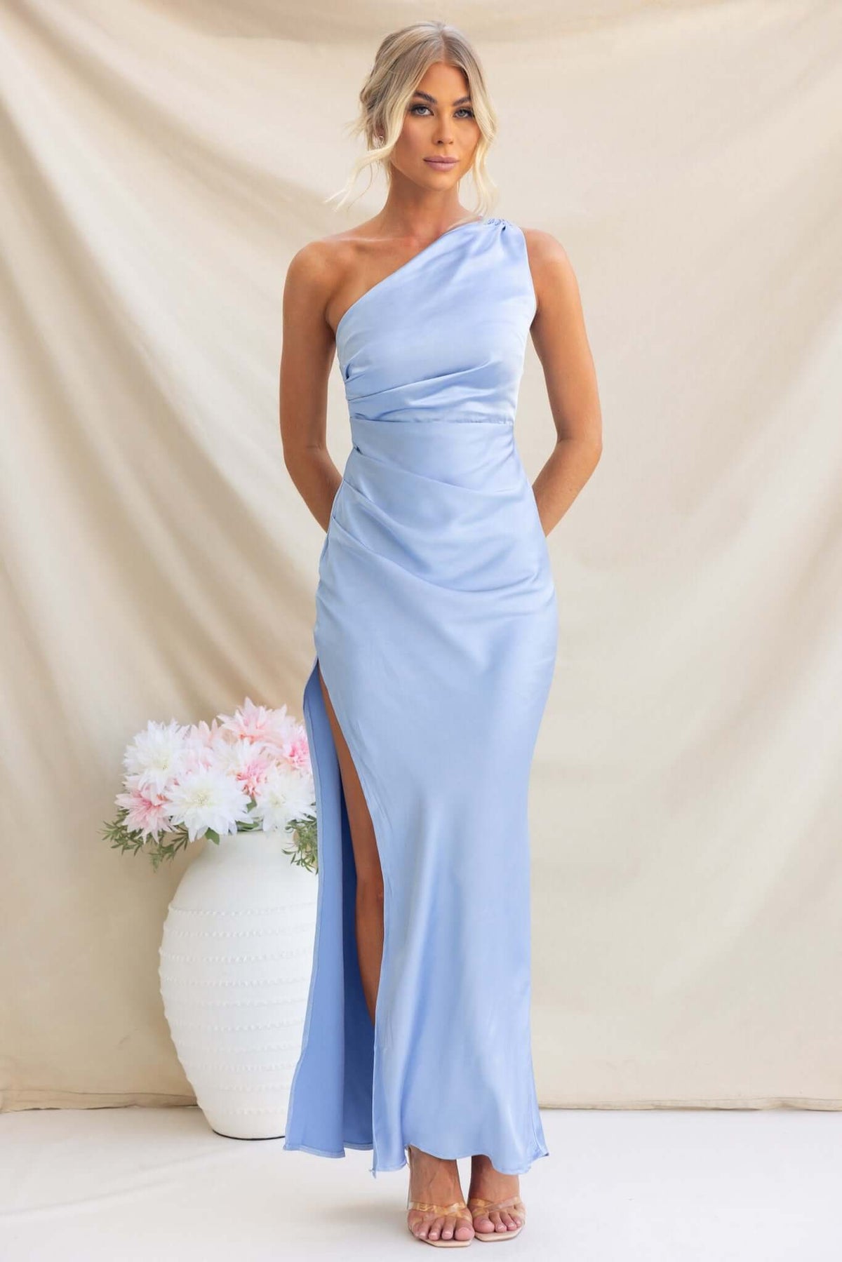 Fahari Maxi Dress in soft blue, featuring one-shoulder design, front split, and elegant satin finish.