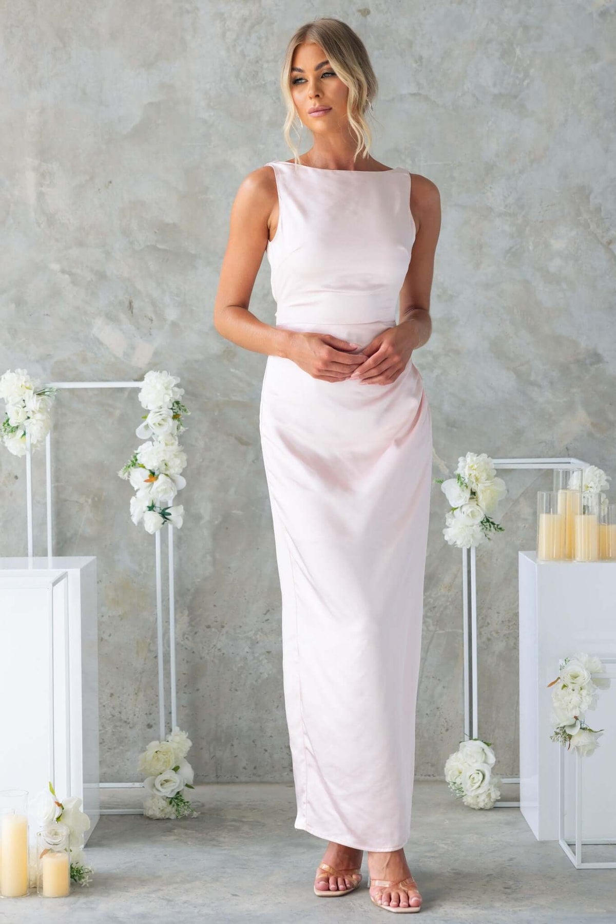 Model wearing Dakari Maxi Dress, a satin high-neck gown with back split and tie details, perfect for formal occasions.