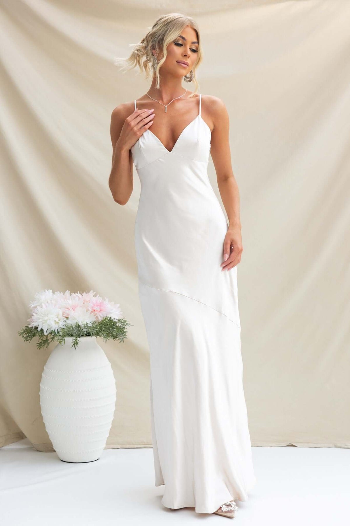 Elegant white Coralina maxi dress with adjustable straps and a fitted silhouette, perfect for formal occasions.